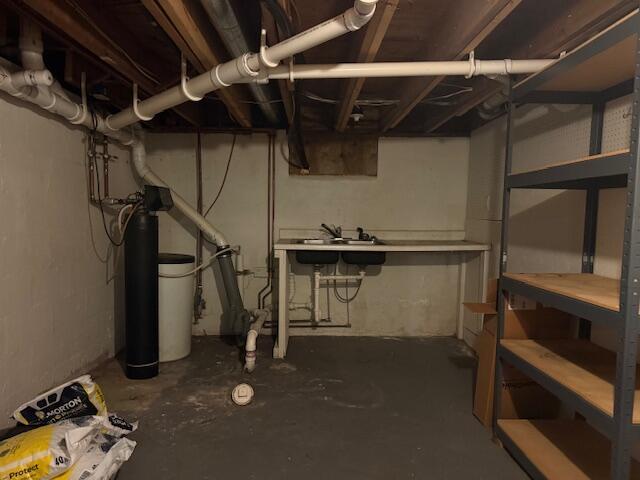 285 Scott St, Newaygo, MI 49337 - unfinished below grade area with a water softener system and a workshop area
