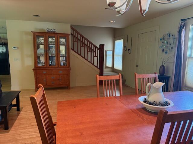 285 Scott St, Newaygo, MI 49337 - dining space with light wood finished floors, stairs, a chandelier, recessed lighting, and baseboards