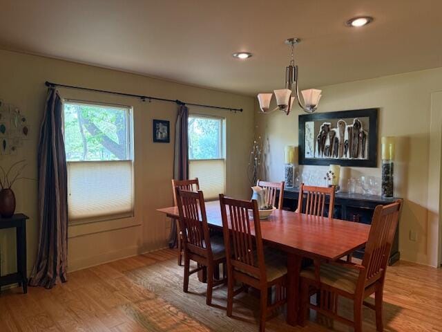 285 Scott St, Newaygo, MI 49337 - dining area with light wood-style flooring, a chandelier, recessed lighting, and baseboards