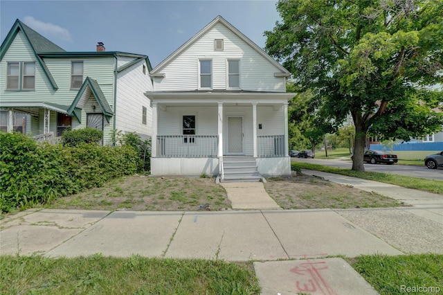 8103 E Canfield St, Detroit, MI 48214 - view of front of home featuring covered porch and a chimney
