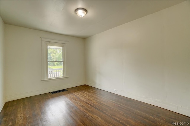 8103 E Canfield St, Detroit, MI 48214 - spare room featuring wood finished floors and baseboards