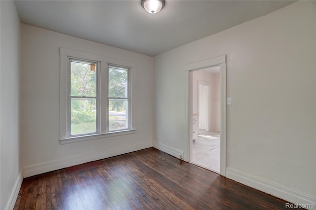 8103 E Canfield St, Detroit, MI 48214 - spare room with baseboards and dark wood-style flooring