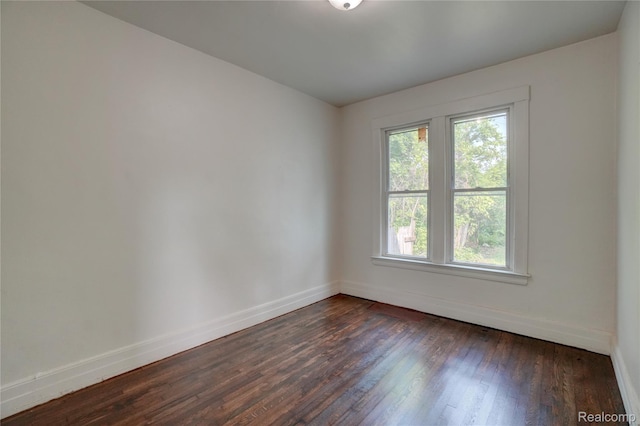 8103 E Canfield St, Detroit, MI 48214 - empty room featuring baseboards and dark wood-style flooring