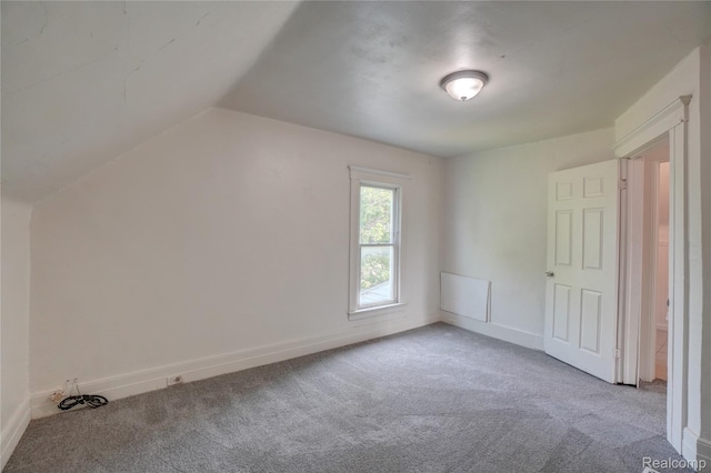 8103 E Canfield St, Detroit, MI 48214 - unfurnished bedroom with carpet floors, baseboards, and vaulted ceiling