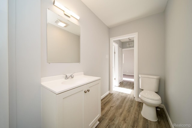 967 Keith St, Oxford, MI 48371 - half bathroom featuring toilet, vanity, wood finished floors, and baseboards
