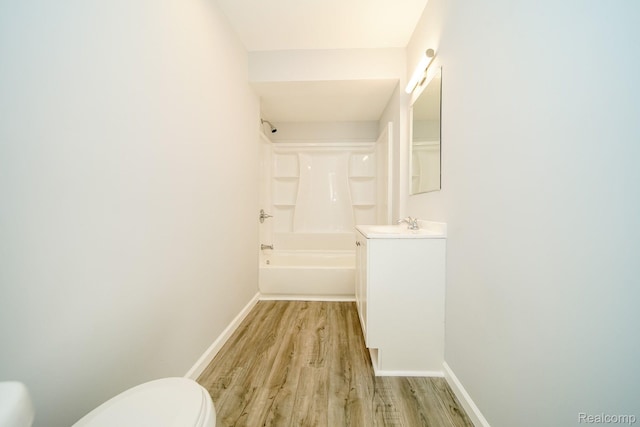 967 Keith St, Oxford, MI 48371 - full bathroom with toilet, wood finished floors, vanity, baseboards, and shower / bath combination