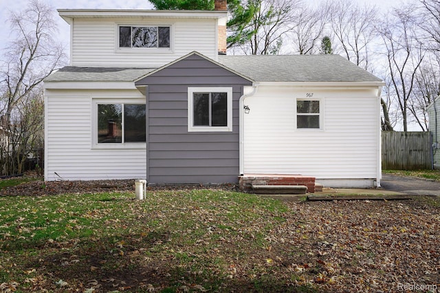 967 Keith St, Oxford, MI 48371 - rear view of house featuring a chimney and roof with shingles