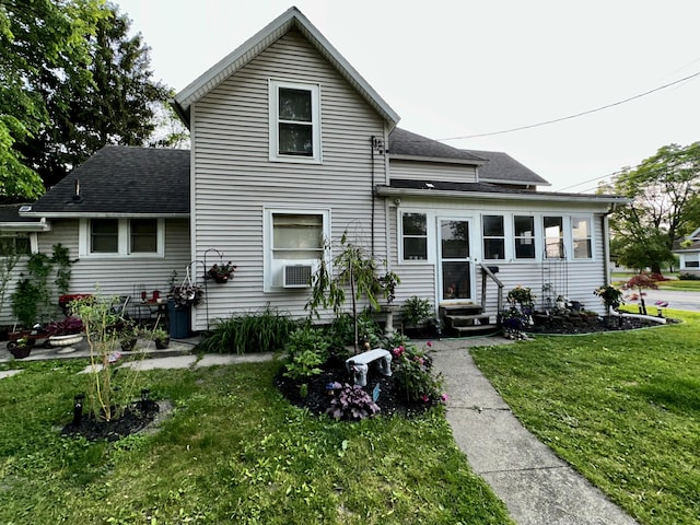 413 E Ganson St, Jackson, MI 49201 - back of property featuring entry steps, a shingled roof, and a yard