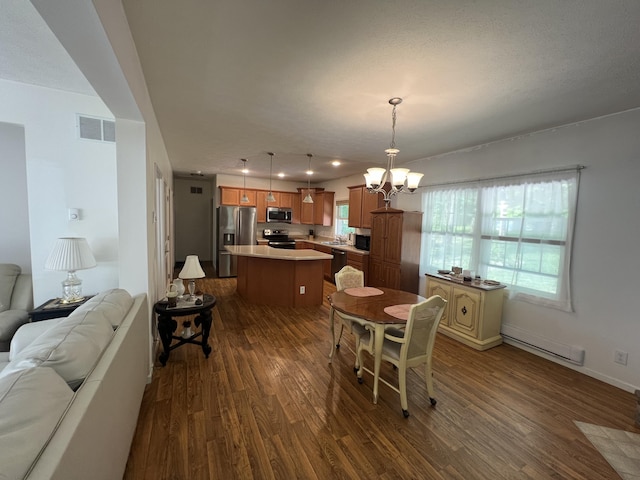 252 E Fenn Rd, Coldwater, MI 49036 - dining space with a baseboard radiator, dark wood finished floors, a chandelier, and baseboards