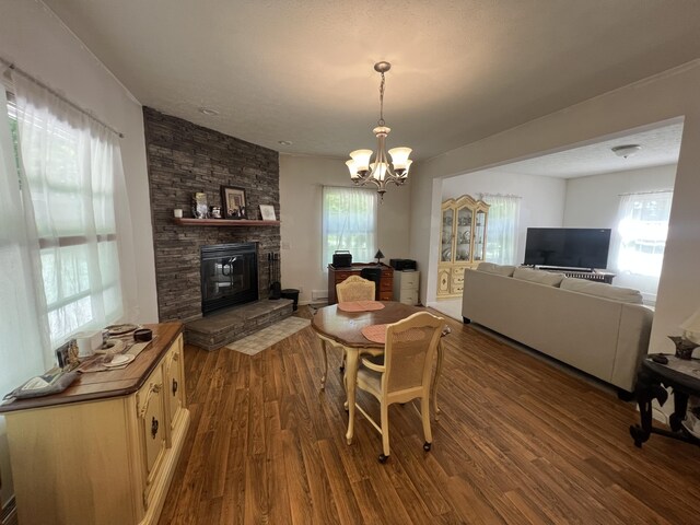 252 E Fenn Rd, Coldwater, MI 49036 - dining room featuring dark wood-style flooring, a chandelier, and a fireplace