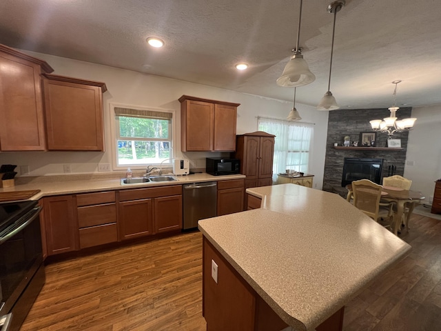 252 E Fenn Rd, Coldwater, MI 49036 - kitchen featuring appliances with stainless steel finishes, a kitchen island, dark wood-style flooring, a sink, and light countertops