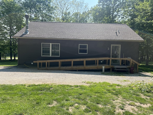 252 E Fenn Rd, Coldwater, MI 49036 - view of front of home featuring a deck, roof with shingles, and a front yard