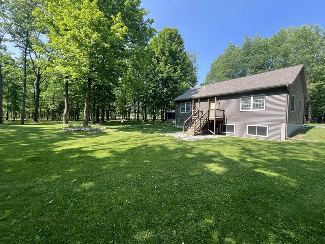252 E Fenn Rd, Coldwater, MI 49036 - view of green lawn featuring stairway and a wooden deck