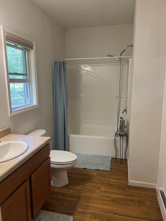 252 E Fenn Rd, Coldwater, MI 49036 - full bathroom with baseboard heating, wood finished floors, vanity, and toilet