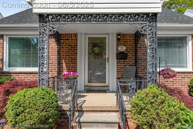 1731 N Franklin St, Dearborn, MI 48128 - view of exterior entry with brick siding, roof with shingles, and covered porch