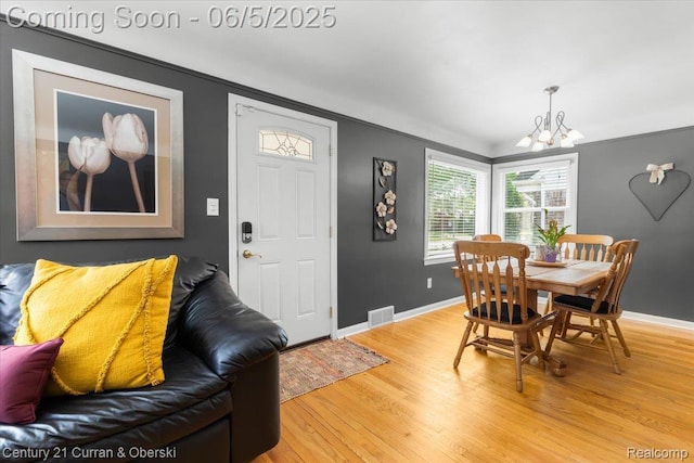 1731 N Franklin St, Dearborn, MI 48128 - dining space with a chandelier, light wood-style flooring, baseboards, and crown molding