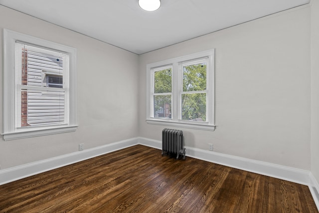 16631 Lawton St, Detroit, MI 48221 - unfurnished room featuring radiator heating unit, dark wood-type flooring, and baseboards