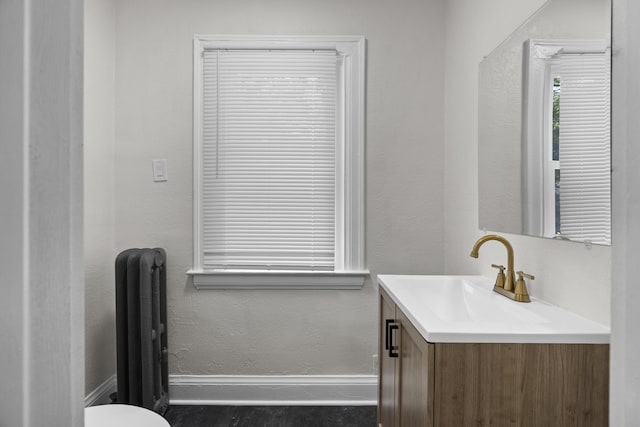 16631 Lawton St, Detroit, MI 48221 - half bath with radiator, baseboards, vanity, and toilet