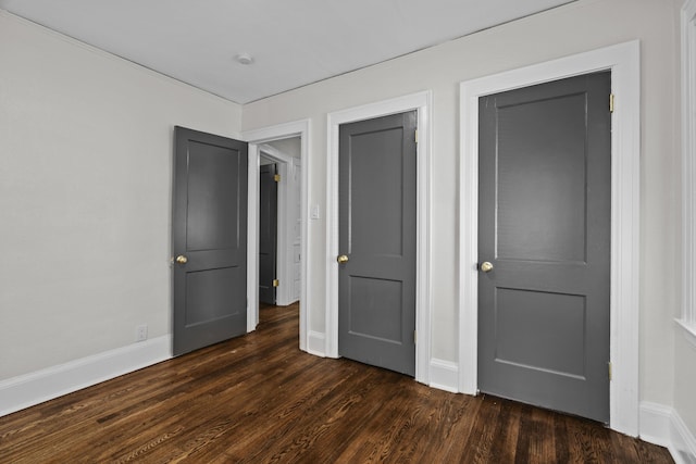 16631 Lawton St, Detroit, MI 48221 - unfurnished bedroom with dark wood-style floors and baseboards