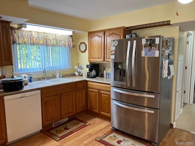 3742 W Barnes Lake Rd, Columbiaville, MI 48421 - kitchen with stainless steel fridge with ice dispenser, dishwasher, light wood-type flooring, a sink, and light countertops