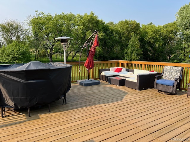 3742 W Barnes Lake Rd, Columbiaville, MI 48421 - wooden deck with an outdoor hangout area and view of wooded area