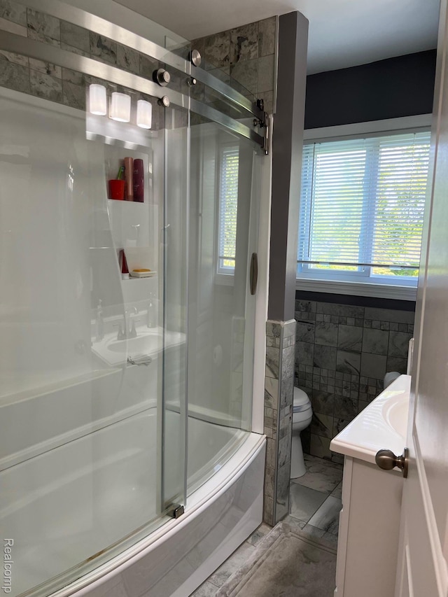3742 W Barnes Lake Rd, Columbiaville, MI 48421 - bathroom with vanity, an enclosed shower, toilet, tile walls, and a bathtub