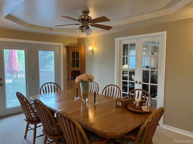 3742 W Barnes Lake Rd, Columbiaville, MI 48421 - dining space featuring light carpet, a ceiling fan, french doors, a raised ceiling, and baseboards