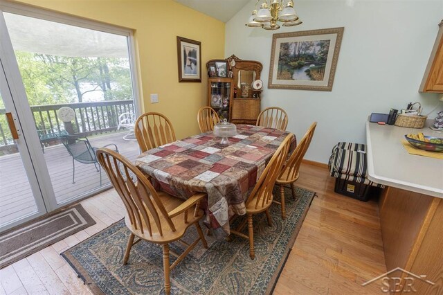 3485 Lakeshore Dr, Lupton, MI 48635 - dining space featuring a chandelier, light wood finished floors, and lofted ceiling