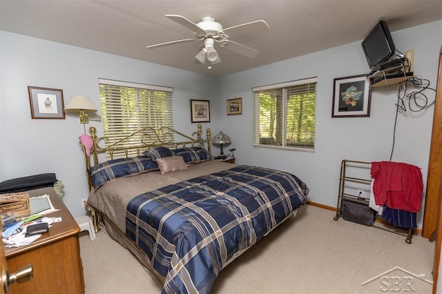 3485 Lakeshore Dr, Lupton, MI 48635 - bedroom featuring carpet flooring, multiple windows, ceiling fan, and baseboards