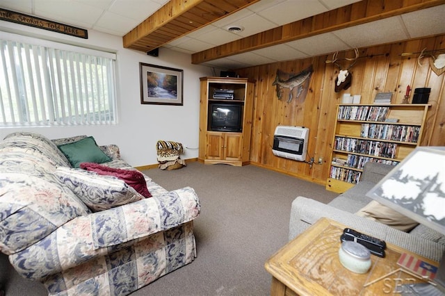 3485 Lakeshore Dr, Lupton, MI 48635 - carpeted living area featuring heating unit, a drop ceiling, wood walls, and baseboards