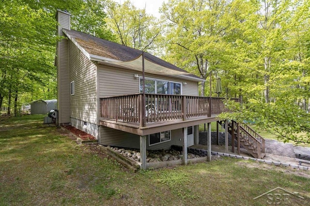 3485 Lakeshore Dr, Lupton, MI 48635 - back of house featuring a chimney, a wooden deck, stairs, and a yard