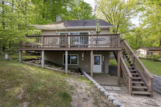 3485 Lakeshore Dr, Lupton, MI 48635 - rear view of house with a wooden deck, stairway, a chimney, and a patio