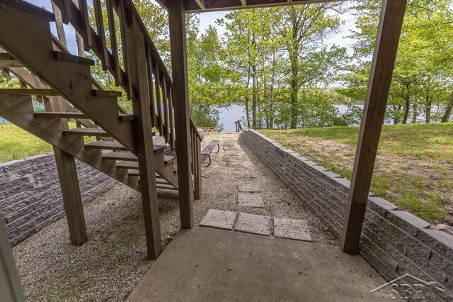 3485 Lakeshore Dr, Lupton, MI 48635 - view of patio with stairway and a water view