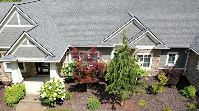 8680 Dexter Pinckney Rd, Pinckney, MI 48169 - craftsman-style home featuring stone siding and roof with shingles