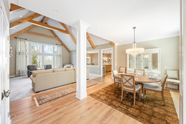 8680 Dexter Pinckney Rd, Pinckney, MI 48169 - dining space with wood finished floors, baseboards, and ornate columns