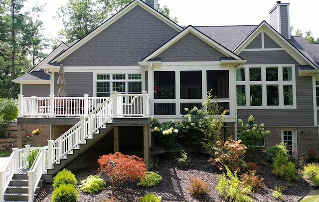 8680 Dexter Pinckney Rd, Pinckney, MI 48169 - rear view of house featuring stairs, a chimney, a wooden deck, a sunroom, and brick siding