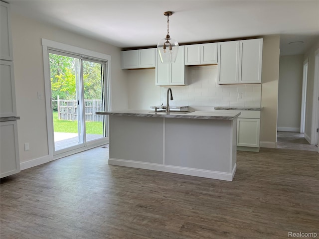5327 E Carpenter Rd, Grand Blanc, MI 48506 - kitchen with wood finished floors, decorative backsplash, and plenty of natural light
