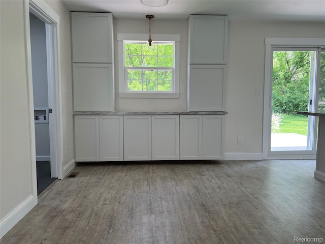 5327 E Carpenter Rd, Grand Blanc, MI 48506 - unfurnished dining area featuring wood finished floors and healthy amount of natural light