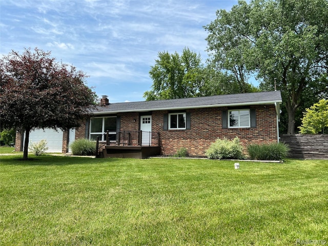 5327 E Carpenter Rd, Grand Blanc, MI 48506 - ranch-style home featuring brick siding, a garage, a front lawn, and a chimney