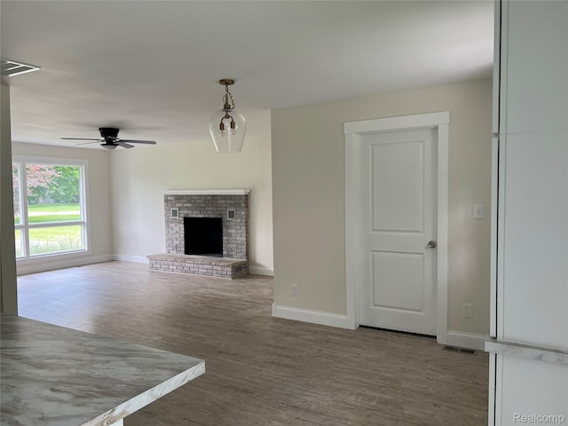 5327 E Carpenter Rd, Grand Blanc, MI 48506 - unfurnished living room with wood finished floors, a ceiling fan, and a fireplace