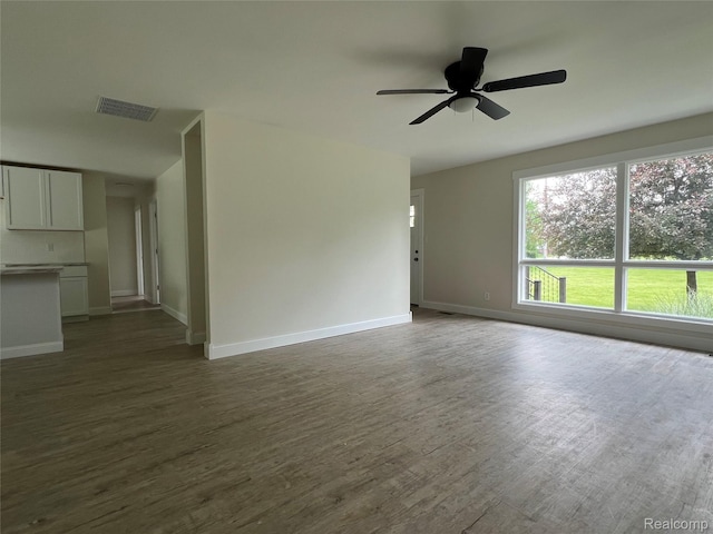5327 E Carpenter Rd, Grand Blanc, MI 48506 - unfurnished living room featuring dark wood-style flooring and a ceiling fan