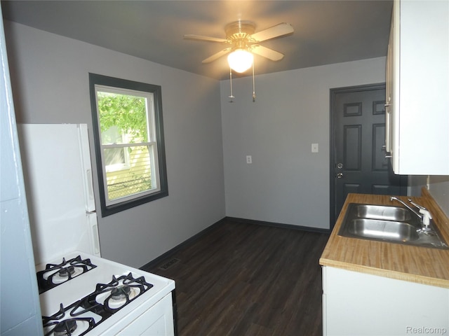 21054 Ehlert Ave, Utica, MI 48089 - kitchen featuring a sink, white appliances, white cabinetry, dark wood-type flooring, and ceiling fan