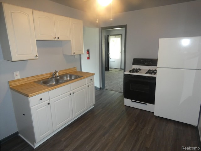 21054 Ehlert Ave, Utica, MI 48089 - kitchen with gas range, a sink, freestanding refrigerator, dark wood-type flooring, and white cabinetry