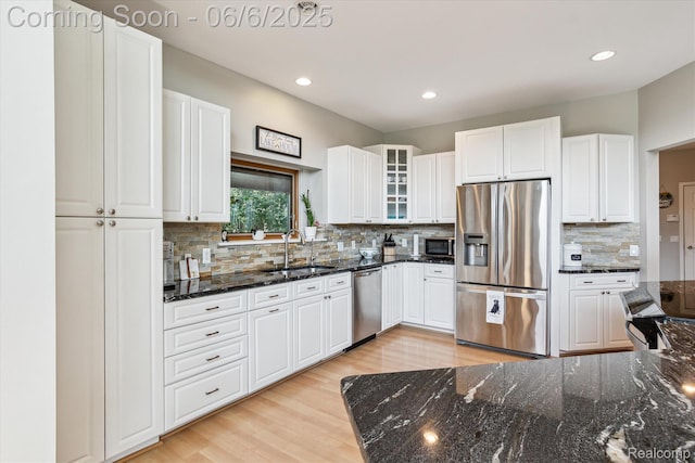 4118 Shoreview Ln, Whitmore Lake, MI 48189 - kitchen featuring appliances with stainless steel finishes, a sink, light wood-style flooring, backsplash, and white cabinets