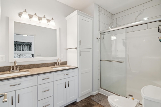 10 Windswept Ln, Hillsdale, MI 49242 - bathroom featuring toilet, a shower stall, and double vanity