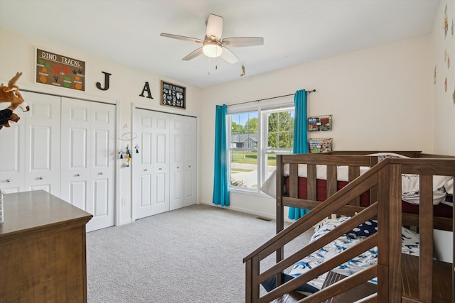 10 Windswept Ln, Hillsdale, MI 49242 - carpeted bedroom featuring two closets, baseboards, and a ceiling fan