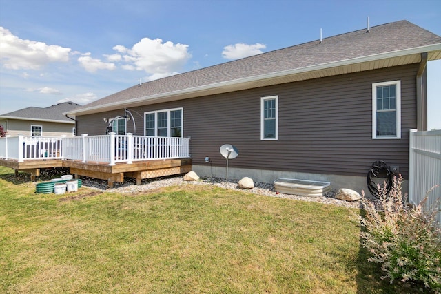 10 Windswept Ln, Hillsdale, MI 49242 - rear view of house featuring a lawn, roof with shingles, and a deck