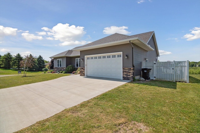 10 Windswept Ln, Hillsdale, MI 49242 - view of front of home with an attached garage, concrete driveway, stone siding, and a gate