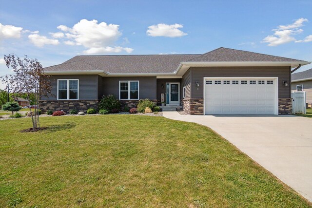 10 Windswept Ln, Hillsdale, MI 49242 - view of front of house with concrete driveway, a garage, stone siding, a front yard, and a shingled roof