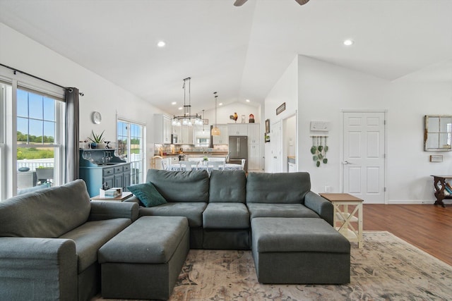 10 Windswept Ln, Hillsdale, MI 49242 - living room featuring vaulted ceiling, wood finished floors, ceiling fan, recessed lighting, and a chandelier
